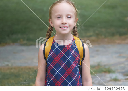 Beaming blonde schoolgirl with a yellow backpack, radiating joy on her way to school, Back to school concept Beaming blonde schoolgirl with a yellow backpack, radiating joy on her way to school, Back to school concept 109430498