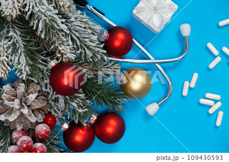 Medicine and winter holidays Christmas and New Year - card with Christmas tree branch and stethoscope 109430593
