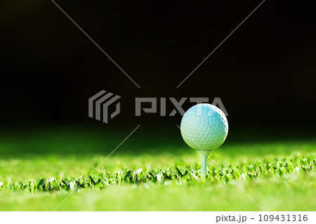 White golf ball on tee closeup 109431316