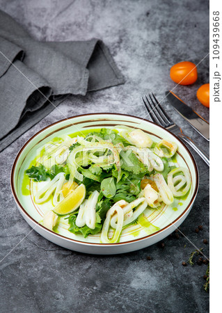salad with arugula, parsley, lime and squid rings, side view salad with arugula, parsley, lime and squid rings, side view 109439668