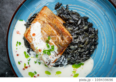 black beans with big fish steak, green onions and cream sauce, top view 109439696