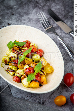 salad of yellow and red cherry tomatoes of different varieties with herbs side view salad of yellow and red cherry tomatoes of different varieties with herbs side view 109439744