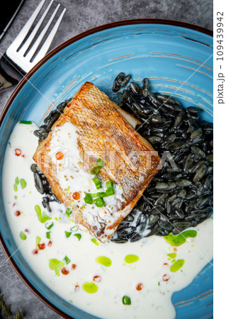 black beans with big fish steak, green onions and cream sauce, top view black beans with big fish steak, green onions and cream sauce, top view 109439942