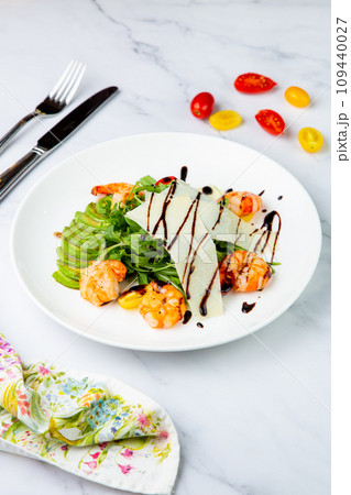 shrimp with avocado slices and arugula with teriyaki sauce side view 109440027