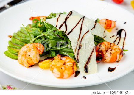 shrimp with avocado slices and arugula with teriyaki sauce side view shrimp with avocado slices and arugula with teriyaki sauce side view 109440029