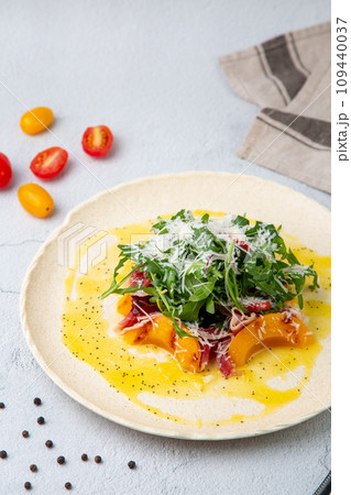 green salad with arugula and lingonberries on a white plate and marble background top view green salad with arugula and lingonberries on a white plate and marble background top view 109440037