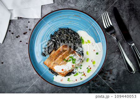 black beans with big fish steak, green onions and cream sauce, top view 109440053