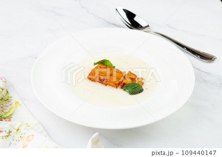 side view of porridge with mint leaves and pieces of meat in sweet and sour sauce side view of porridge with mint leaves and pieces of meat in sweet and sour sauce 109440147
