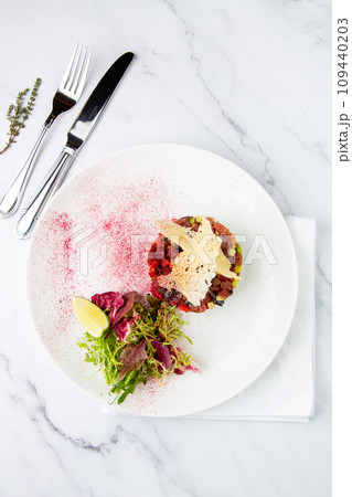 meat salad with arugula and lime, top view meat salad with arugula and lime, top view 109440203