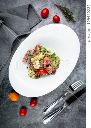 salad of tomatoes, zucchini, grated garlic with a lot of sesame seeds, top view 109440222