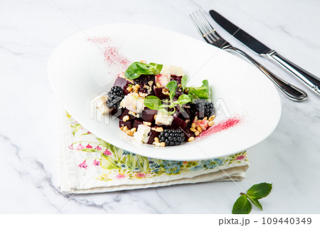 salad of blackberries, beets, seeds and cheese, side view on a white plate salad of blackberries, beets, seeds and cheese, side view on a white plate 109440349
