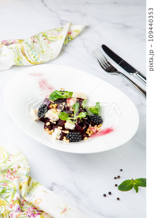 salad of blackberries, beets, seeds and cheese, side view on a white plate salad of blackberries, beets, seeds and cheese, side view on a white plate 109440353