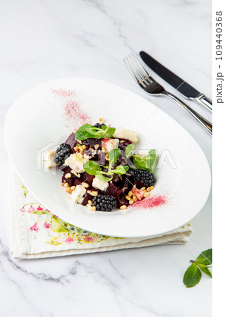salad of blackberries, beets, seeds and cheese, side view on a white plate salad of blackberries, beets, seeds and cheese, side view on a white plate 109440368