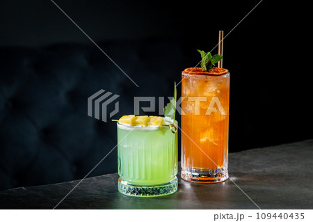 tropical cocktail with sunset gradient and citrus side view tropical cocktail with sunset gradient and citrus side view 109440435