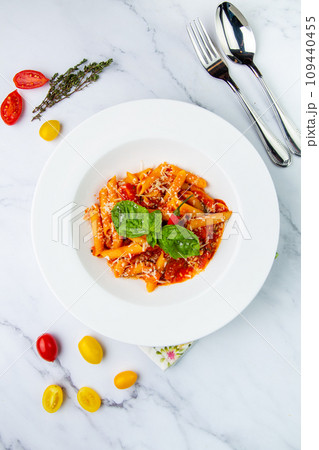 pasta in tomato sauce with cheese and herbs top view 109440455