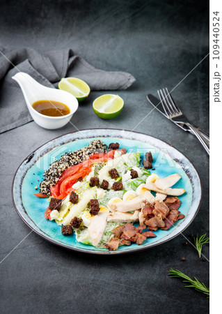 different types of meat, sesame seeds, greens and croutons, side view 109440524