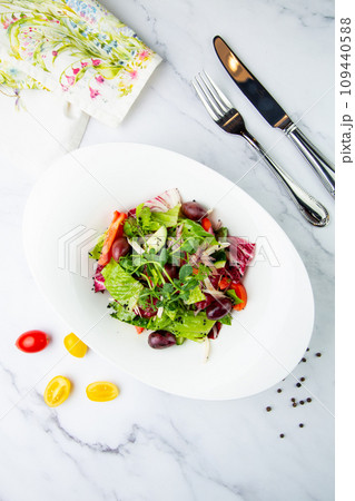 salad of greens, lettuce leaves, cucumbers, pink onions, side view salad of greens, lettuce leaves, cucumbers, pink onions, side view 109440588