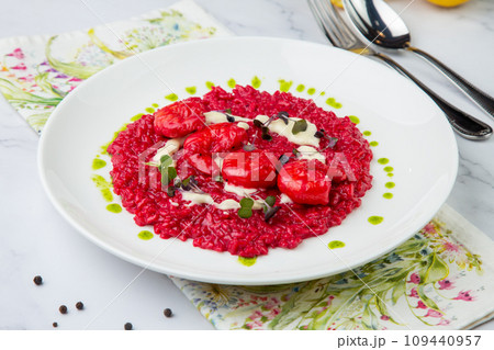 shrimp with beans and herbs in red sauce, side view 109440957