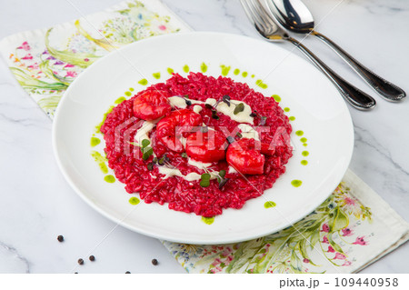 shrimp with beans and herbs in red sauce, side view 109440958