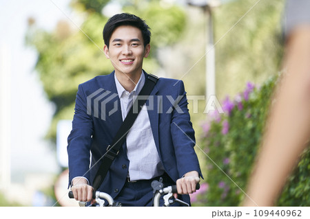 young asian business man commuting by bike young asian business man commuting by bike 109440962