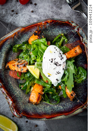 salad with spinach, eel, lime, sour cream, side view 109441214