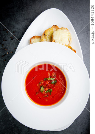 borscht with herbs in a white plate with pieces of bread top view 109441226