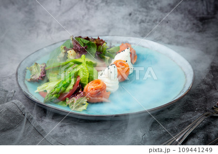 salad of leaves of different types of lettuce and fish rolls, top view 109441249
