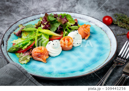 salad of leaves of different types of lettuce and fish rolls, top view 109441256