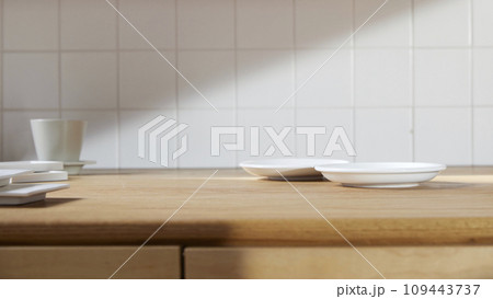 A sunny kitchen with white tile walls, a wooden table and sink. A sunny kitchen with white tile walls, a wooden table and sink. 109443737