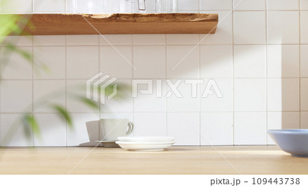 A sunny kitchen with white tile walls, a wooden table and sink. 109443738