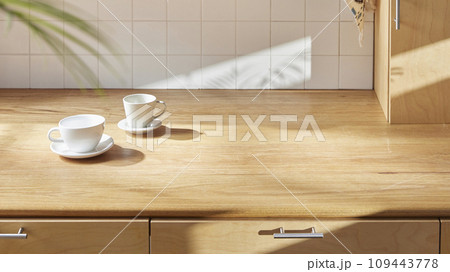 A sunny kitchen with white tile walls, a wooden table and sink. 109443778