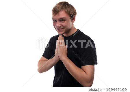 European teenage guy with brown hair smiles while talking 109445100