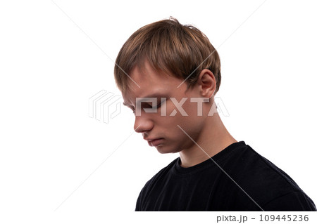 Handsome Caucasian blond teenager guy in a black T-shirt is upset because of problems Handsome Caucasian blond teenager guy in a black T-shirt is upset because of problems 109445236