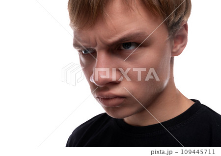 Offended young man with blond hair wearing a black T-shirt Offended young man with blond hair wearing a black T-shirt 109445711