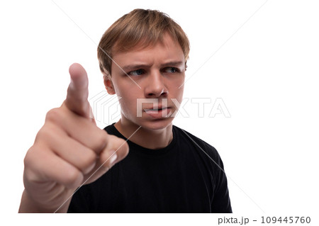 Headshot portrait of a suspicious blond Caucasian guy with blond hair looking from under his brows Headshot portrait of a suspicious blond Caucasian guy with blond hair looking from under his brows 109445760