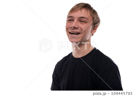 Handsome Caucasian blond teenager guy in a black T-shirt is friendly 109445785