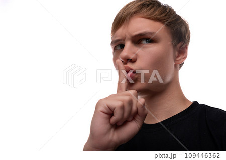Portrait of a charming teenage guy with light brown hair keeping a secret Portrait of a charming teenage guy with light brown hair keeping a secret 109446362