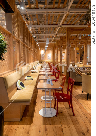 Loft style restaurant with textured wooden walls. Cafe restaurant in wooden style. There are plenty of tables with chairs and armchairs. Empty coffee without people. Loft style restaurant with textured wooden walls. Cafe restaurant in wooden style. There are plenty of tables with chairs and armchairs. Empty coffee without people. 109448438