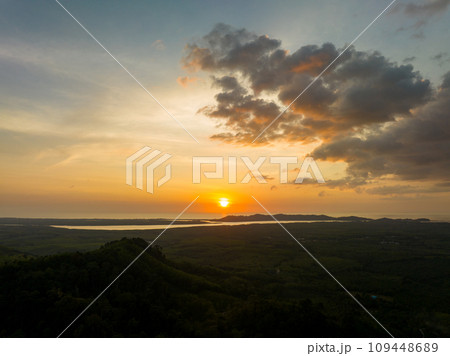 Aerial view colorful sky over mountains tropical rainforest,Bird eye view image over the fog, Amazing nature background with clouds and mountain peaks in Thailand 109448689