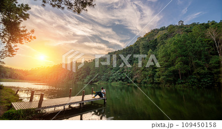 Traveller wiht tablet is relax in Pang Ung Lake ,North of Thailand 109450158