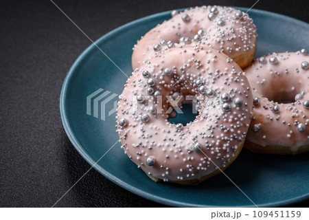 Delicious fresh donut of white or beige color with silver beads and cream 109451159