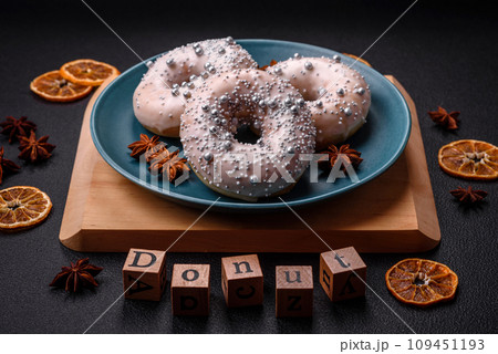 Delicious fresh donut of white or beige color with silver beads and cream 109451193
