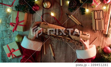 Santa Claus Crafting a toy train as Christmas present 109451281