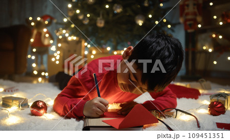 Kid writing Christmas letter for santa Claus Kid writing Christmas letter for santa Claus 109451351