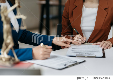 Legal counsel presents to the client a signed contract with legal law. justice and lawyer concept in office. Legal counsel presents to the client a signed contract with legal law. justice and lawyer concept in office. 109452463