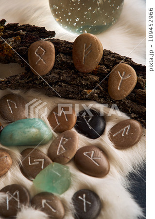 handmade stone runes on white fur handmade stone runes on white fur 109452966