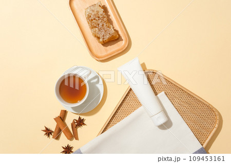 Unbranded tube displayed with a cup of tea and wooden dish of beeswax. Raw honey contains many important antioxidants. Star anise and cinnamon featured Unbranded tube displayed with a cup of tea and wooden dish of beeswax. Raw honey contains many important antioxidants. Star anise and cinnamon featured 109453161