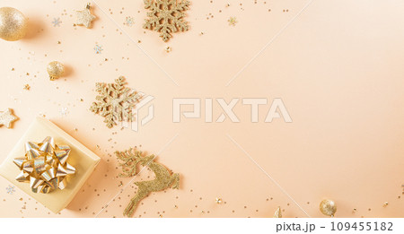 Happy New year celebration background concept. Golden gift box, stars, christmas ball and champagne on pastel background. 109455182