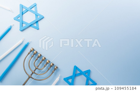 Jewish holiday Hanukkah concept. Top view of goldren menorah on pastel blue background. Jewish holiday Hanukkah concept. Top view of goldren menorah on pastel blue background. 109455184