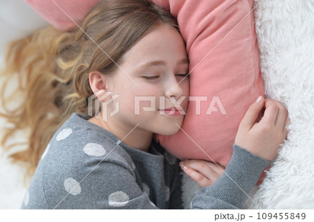 Sweet little girl sleeping in a bed 109455849